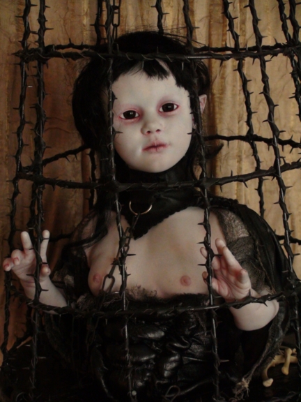 the Llamia gothic art doll in a cage