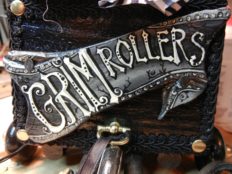 close-up of hand painted lettered art sign goth lettering reads Grim Rollers