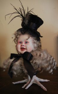 mixed media gothic victorian artdoll porcelain babydoll head wearing black tophat and ribbon on feathered bird body with taxidermy bird feet