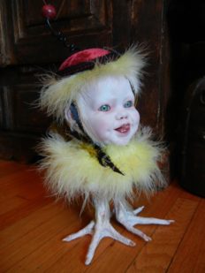 mixed media gothic victorian artdoll porcelain joyful babydoll head wearing black tophat and ribbon on feathered bird body with taxidermy bird feet