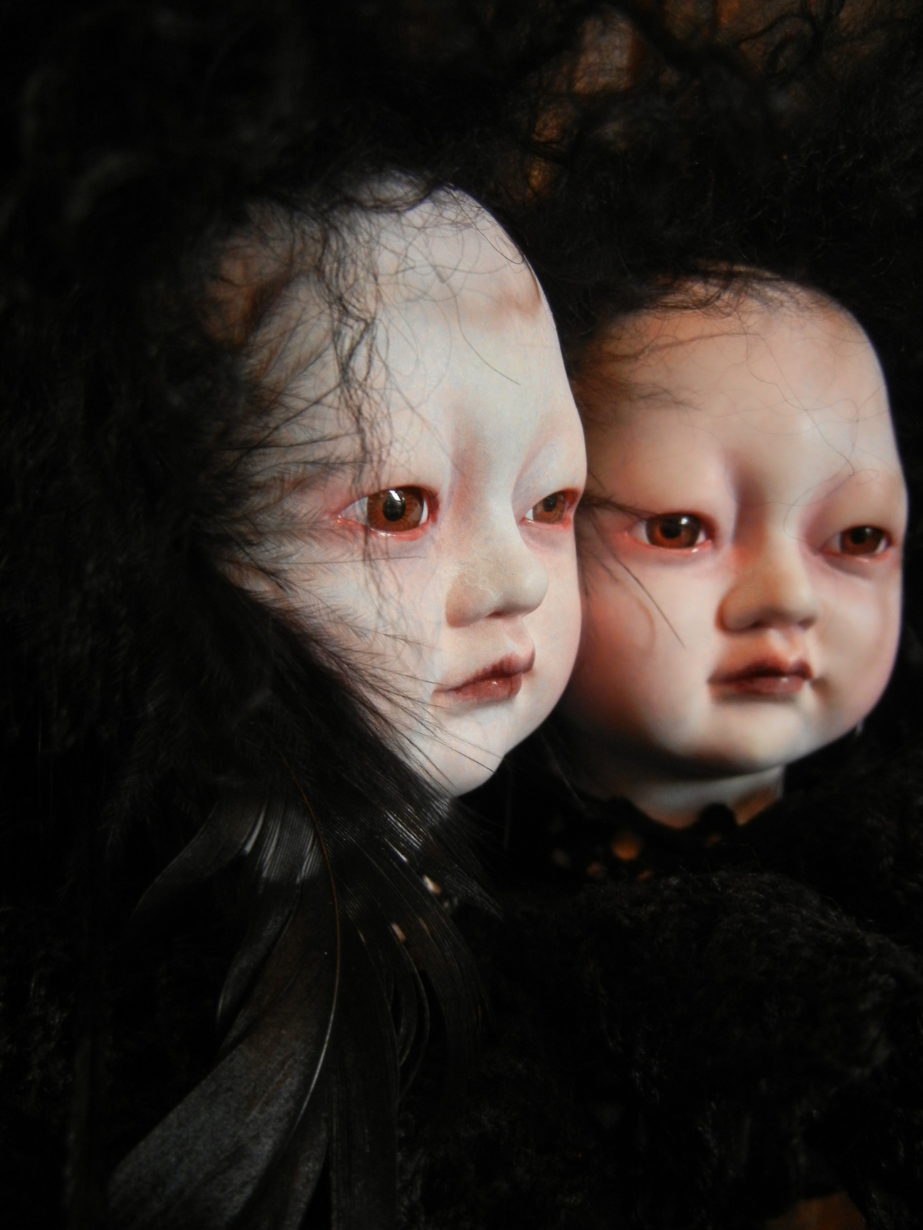 the faces of conjoined twins sisters artdoll, Asian babydoll repaint gothic artdoll faces with black hair and black feathers