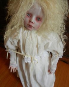 gothic vampire artdoll with white blond hair and fangs in a white nightgown