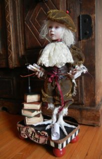 gothic romantic poet artdoll wearing brown velvet and lace scarf, taxidermy birdfeet surrounded by antique books and scrolls standing on hand-painted wooden platform
