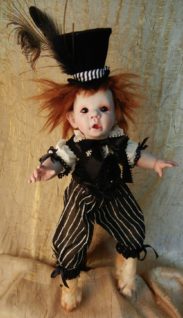 mixed media artdoll porcelain doll red hair, repainted face wears feathered top hat and bloomers taxidermied feet