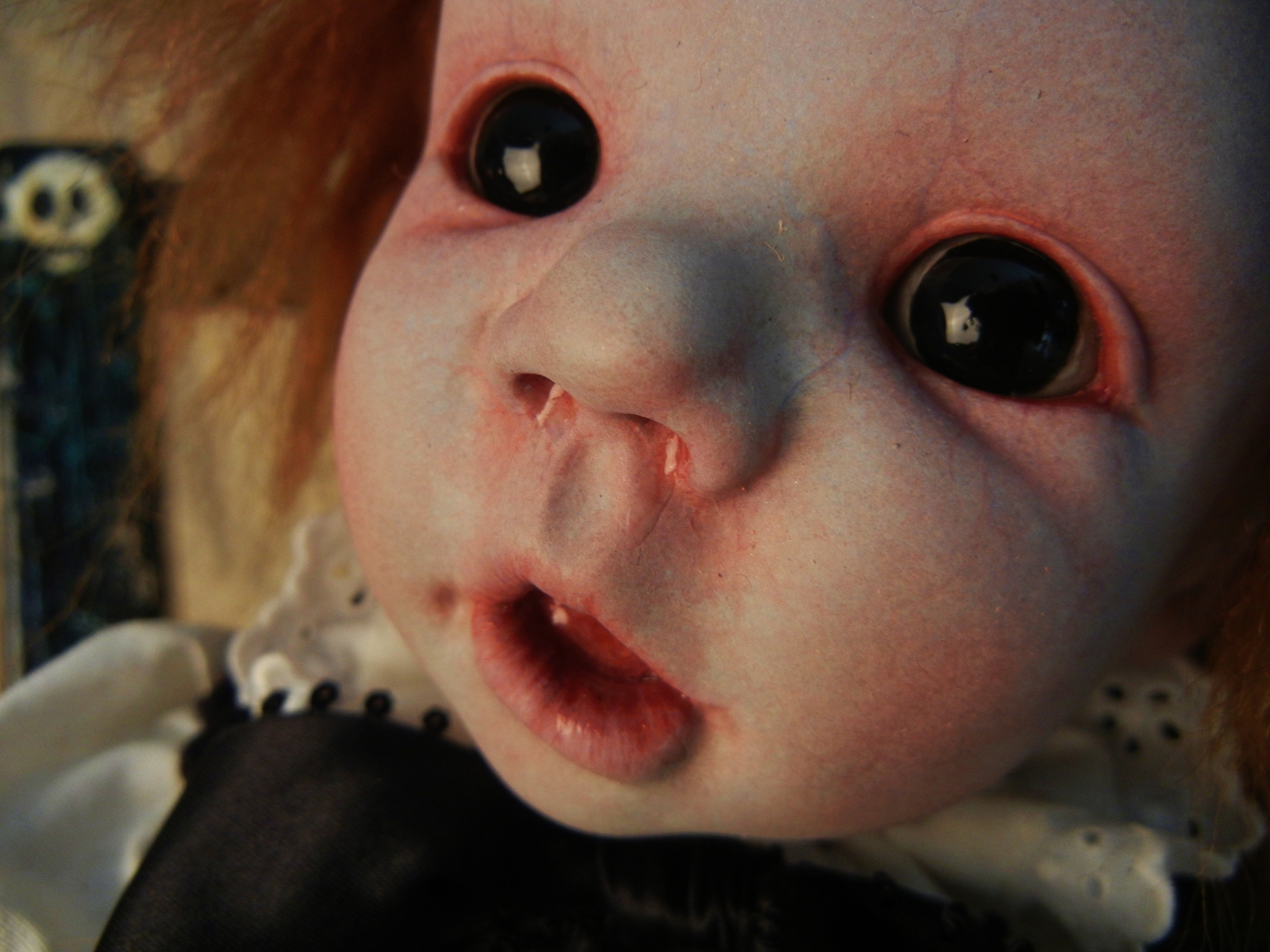 porcelain doll face repainted gothic black eyes, pale, open-mouth rosy cheeks red hair