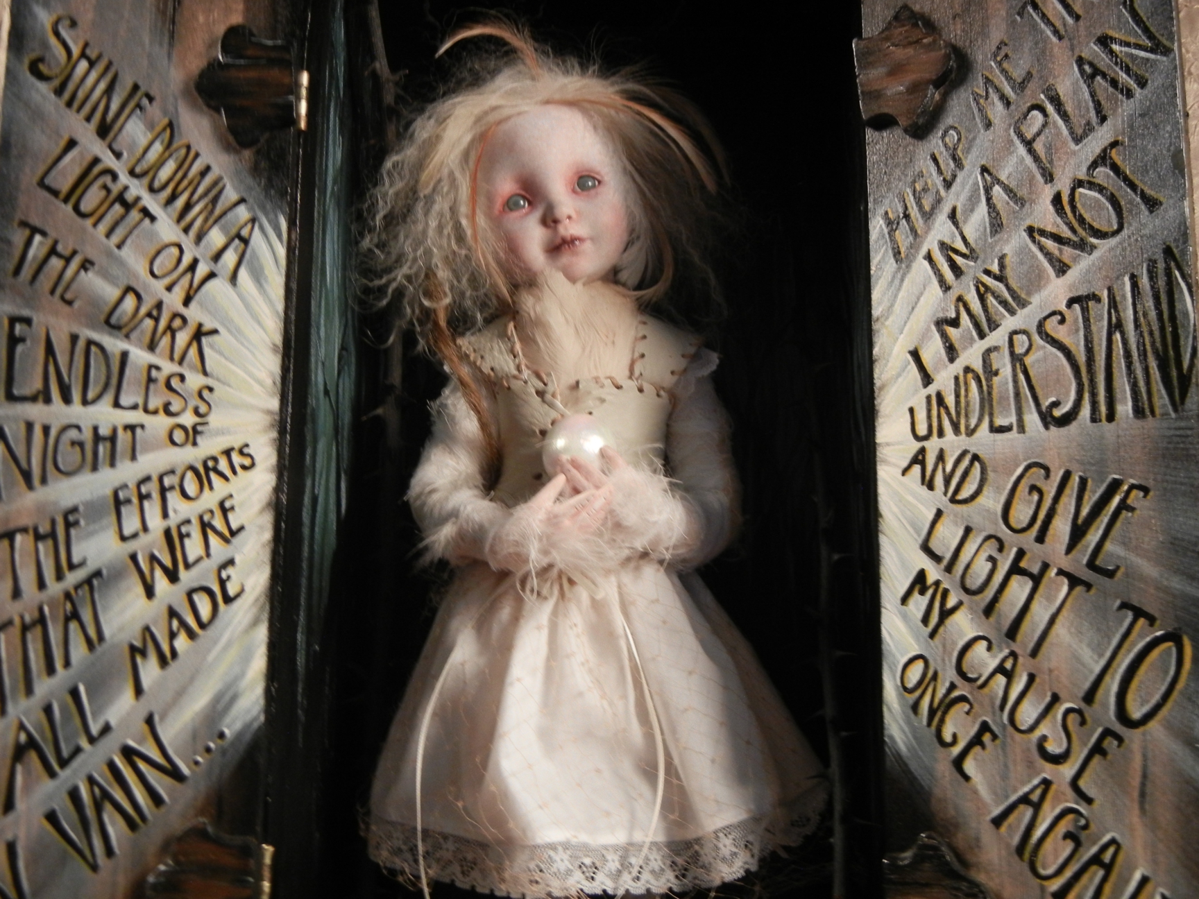 close-up open mixed media cabinet reveals taxidermy artdoll assemblage blonde wild doll in white dress with bird feet