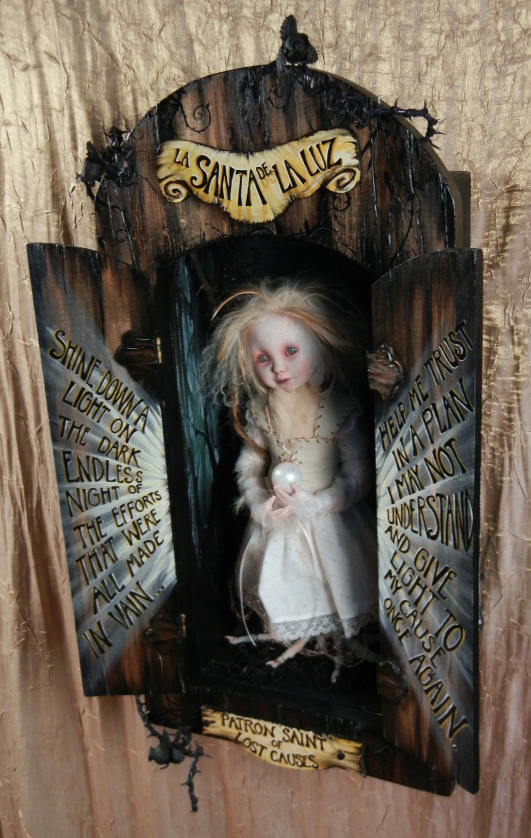 open mixed media cabinet reveals taxidermy artdoll assemblage blonde wild doll in white dress with bird feet holding pearl