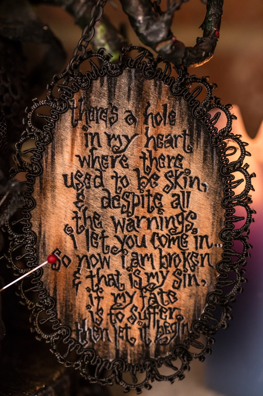 close-up of hand-painted poem on wooden board black lettering