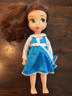 a disney princess belle doll wearing blue dress