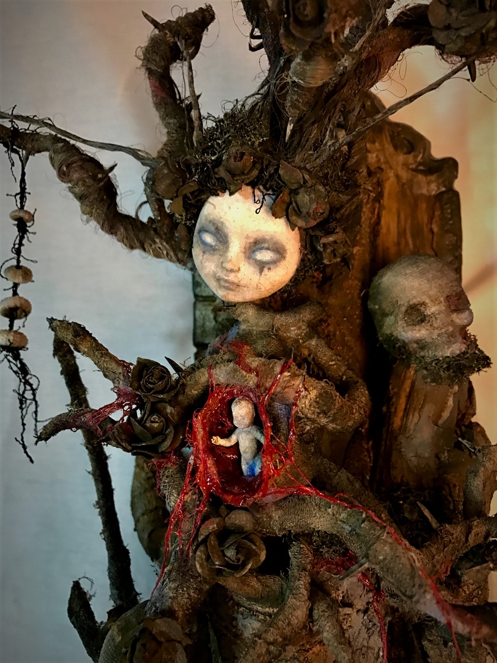 close up mixed media assemblage dark art sculpture monster woman open womb