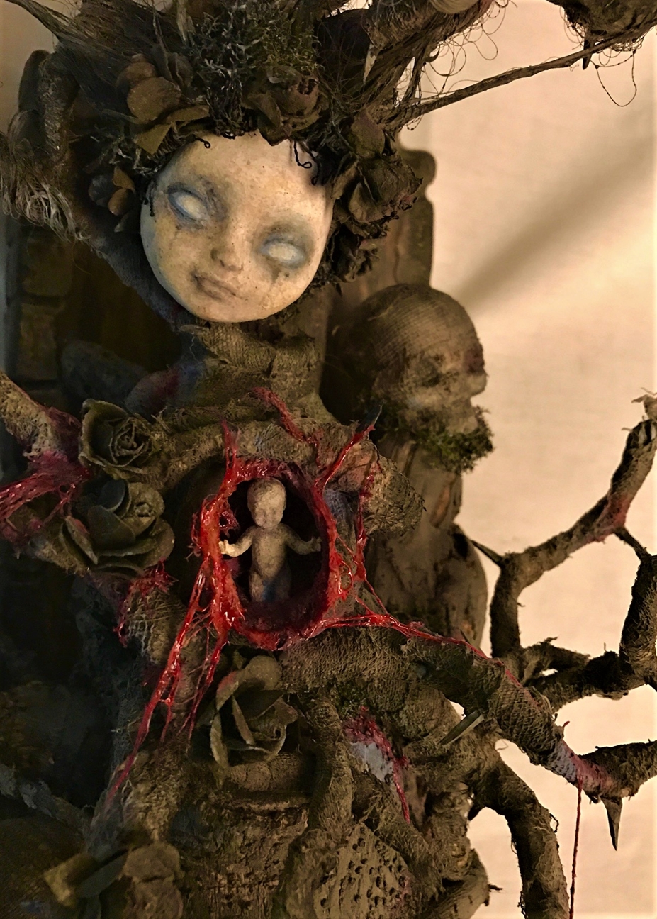 close up mixed media assemblage dark art sculpture monster woman open womb skull