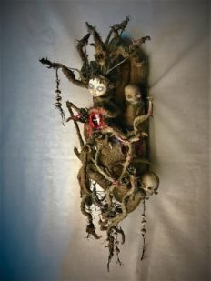 close up mixed media assemblage dark art sculpture monster woman open womb thorns skulls