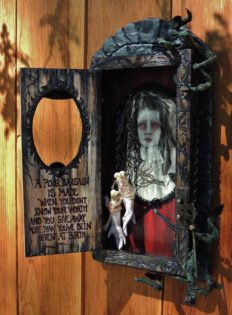 mixed media shadow box cabinet holding severed maiden's hands and a portrait of her beloved hand painted poem on the door