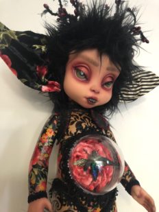 close-up gothic repaint fantasy mythical sprite doll decoupaged with colorful paper and trims big eared and acrylic belly with preserved beetle