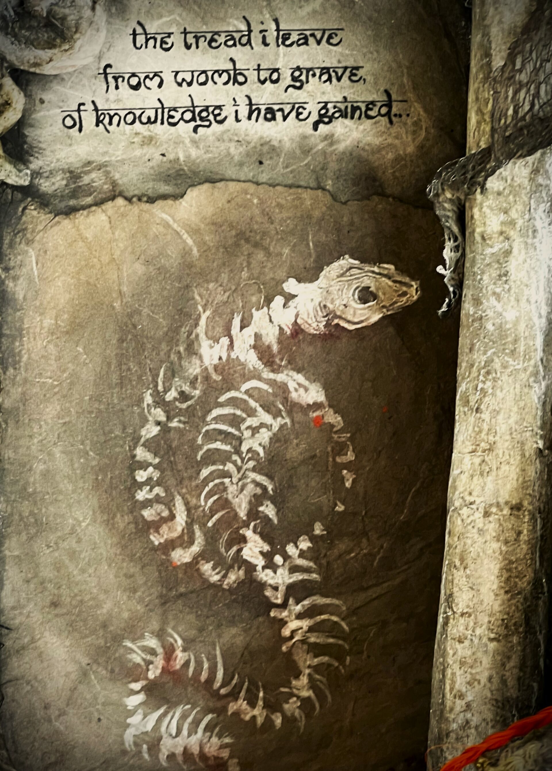 detail of snake skeleton painting with poem above