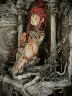 adorned snake goddess doll reclining between skull pillars