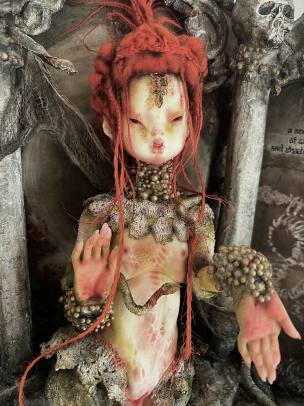adorned snake goddess doll