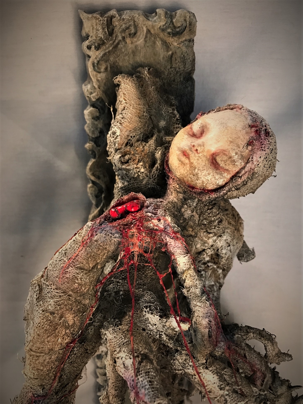close up of wounded woman bleeding heart mixed media assemblage sculpture made of porcelain, cloth mache & wood