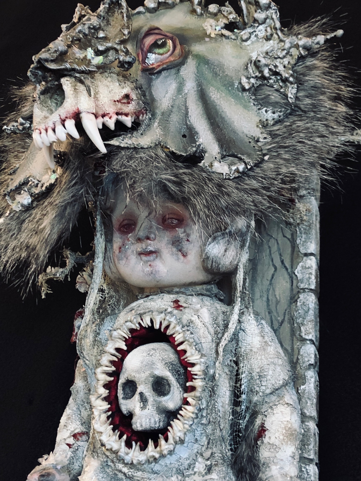 close-up of mixed media assemblage plaque white winter warrior doll wearing a wolf skull headdress