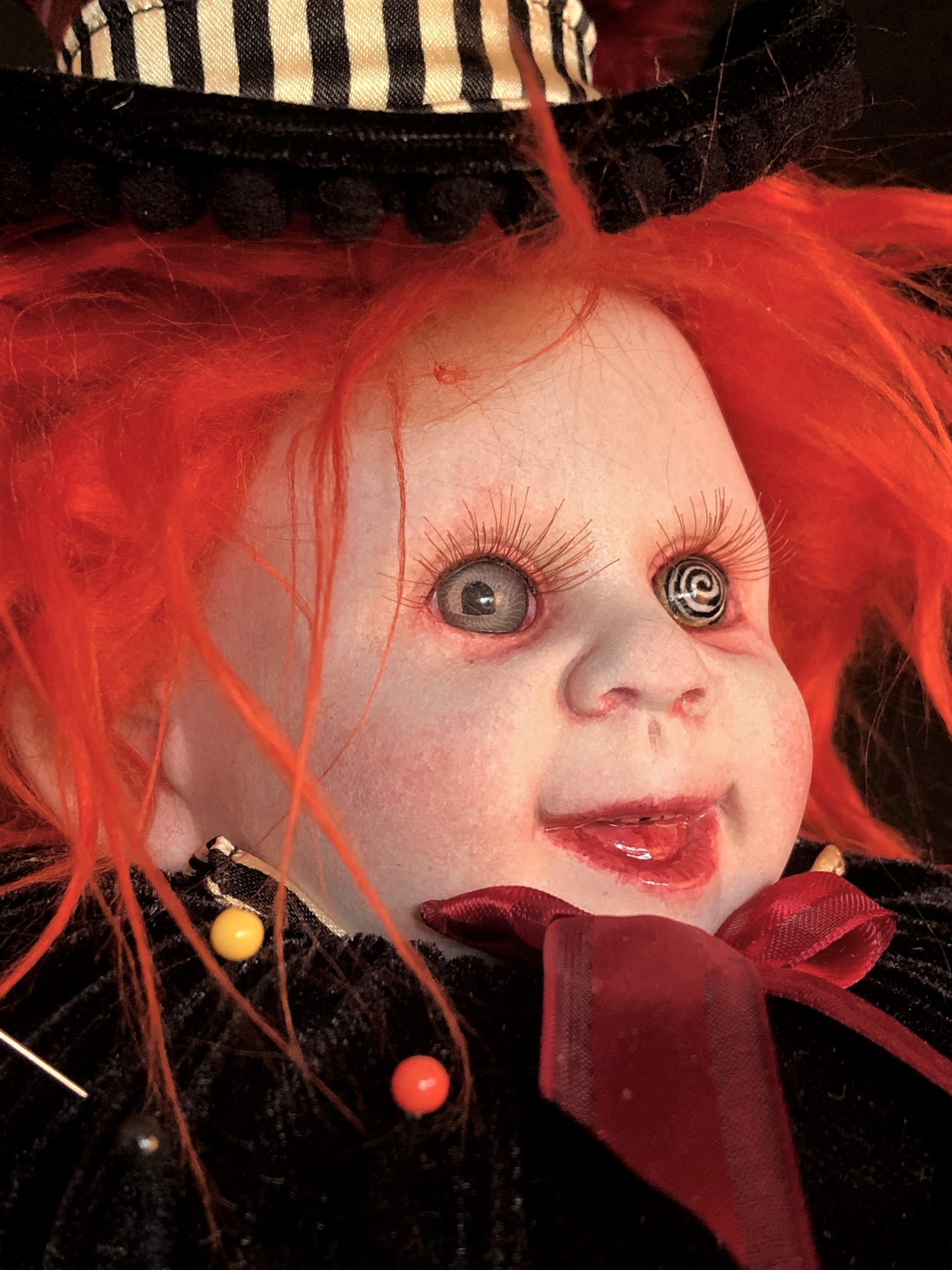 mad hatter themed pincushion porcelain doll head crazy eyes with bright orange hair and velvet tophat stuck with pins