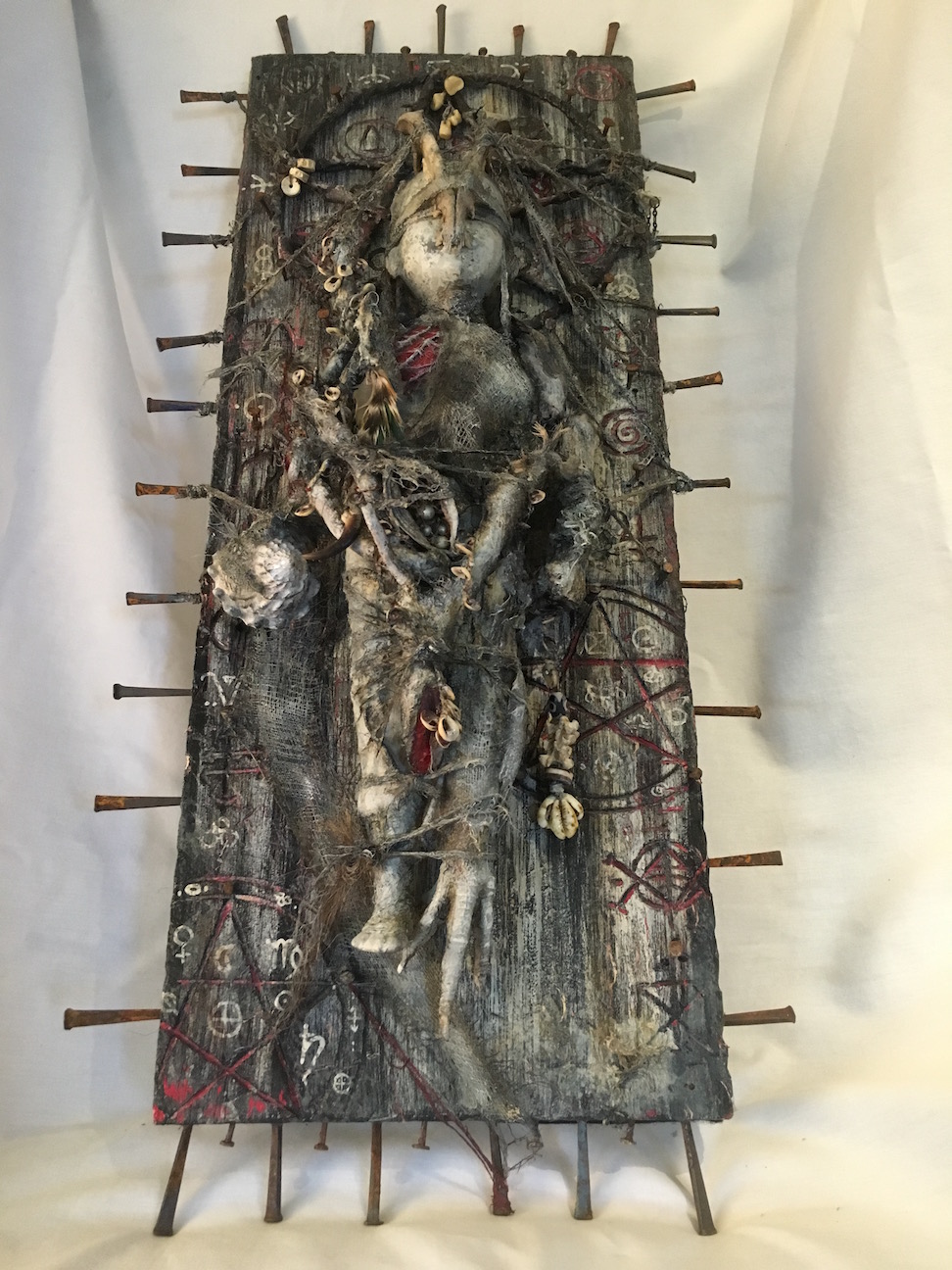 mixed media assemblage plaque hand-painted babydoll with animal bones and pagan symbols
