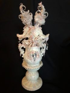 back view of white rococo baroque mixed media assemblage conjoined bird dolls in a vase on pedestal