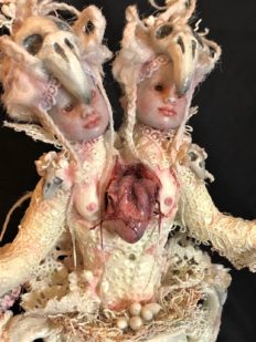 close-up of white rococo baroque mixed media assemblage conjoined bird dolls with open bleeding heart