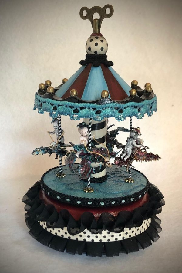 gothic striped carousel music box with four tiny ghost skeletons riding bejeweled beetles black, blue, red and white