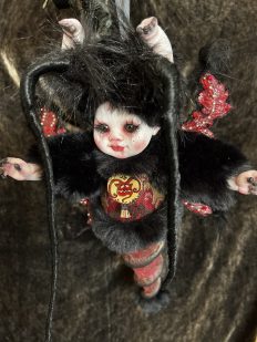 gothic art doll baby moth hybrid with black fur and red body, long eyelashes, devil pendant