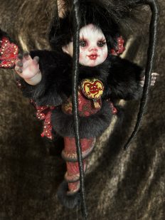gothic art doll baby moth hybrid with black fur and red body, long eyelashes, devil pendant