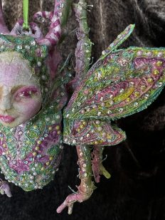 close up Papier-mâché pink and green jewelled beetle ornament mixed media art