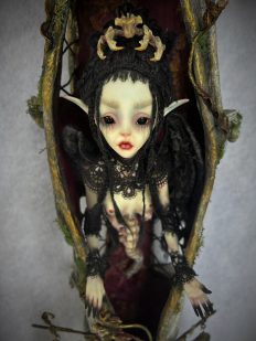 close up of dark faerie in her House of Intentions