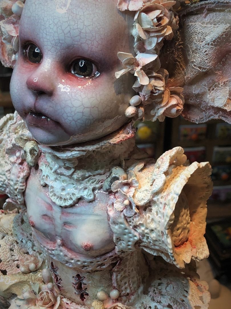 face closeup of mixed media assemblage porcelain doll dark art