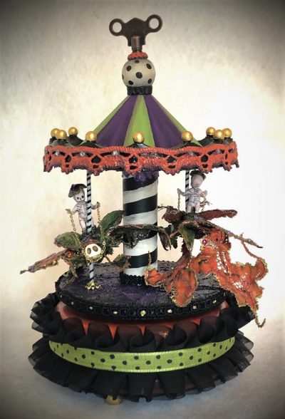 gothic striped carousel music box with tiny ghost skeletons riding bejeweled beetles black, orange, purple and green