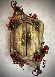 Mixed media sculpted Faerie House with doors, tiny windows and flowering vine