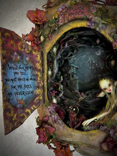Close up of mixed media sculpted Faerie House with poem inscribed on open door