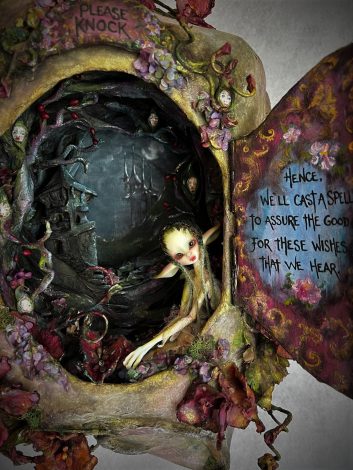 Close up of mixed media sculpted Faerie House with poem inscribed on open door