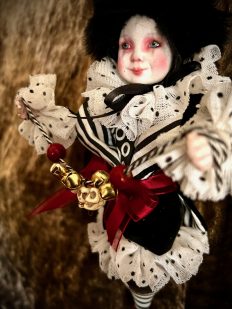 close-up porcelain and wooden doll christmas ornament black, white and red