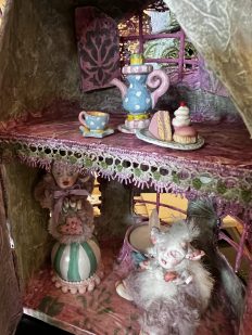 close-up miniature fairy house with furry mouse creatures tea party