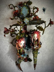 Mixed media assemblage of hanging twin flower fae with dreamscape and flowering vine