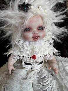 close-up of the angel end of Topsy Turvy flippable doll with white hair and white lace dress