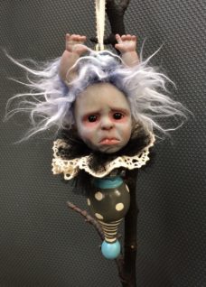 hand painted vinyl doll head with light purple and white fur hair and doll hands coming out of it's head white lace collar attached to hand painted finial with baby blue details gothic Christmas tree holiday ornament