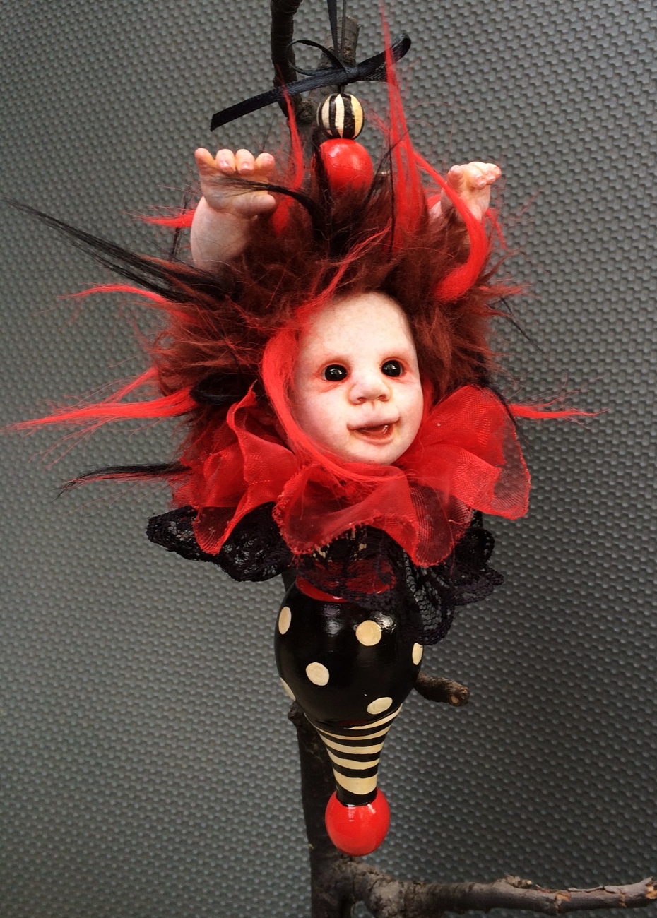 hand painted vinyl doll head with red and black fur hair and doll hands coming out of it's head black lace collar attached to hand painted finial gothic Christmas tree holiday ornament