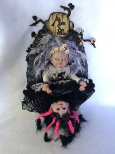 skirt is lifted to see two heads of this gothic artdoll with a lighter doll on top the dolls are holding hands