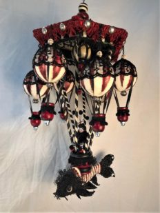 red, black and white mixed media mobile striped miniature gothic circus performer rides a hot air balloon with a lace-covered koi fish