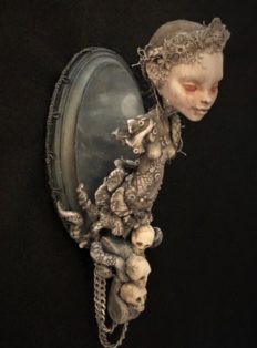 Mixed media sculpted assemblage of a haunting miniature ship figurehead with skulls tentacles