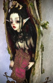 close up of mixed media assemblage dark faerie granting wishes in her House of Intention