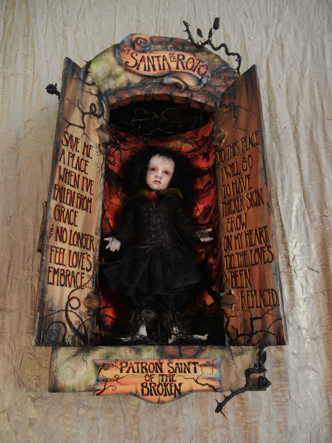 open mixed media cabinet reveals taxidermy artdoll assemblage pale doll with black hair wearing black goth