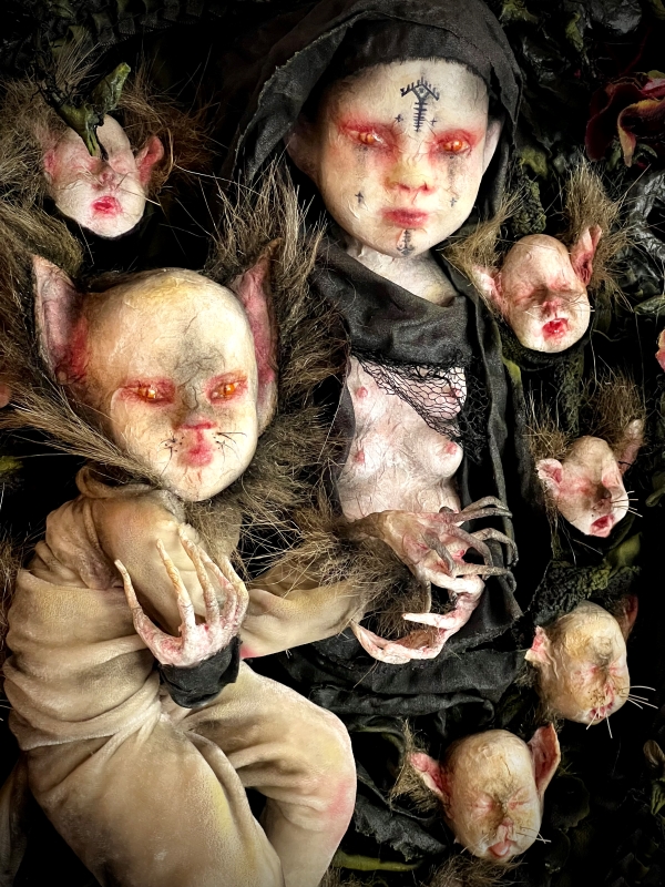 Mother of Cats is a one of a kind sculpture by dark artist Stefanie Vega featuring a cat woman creature and her kittens