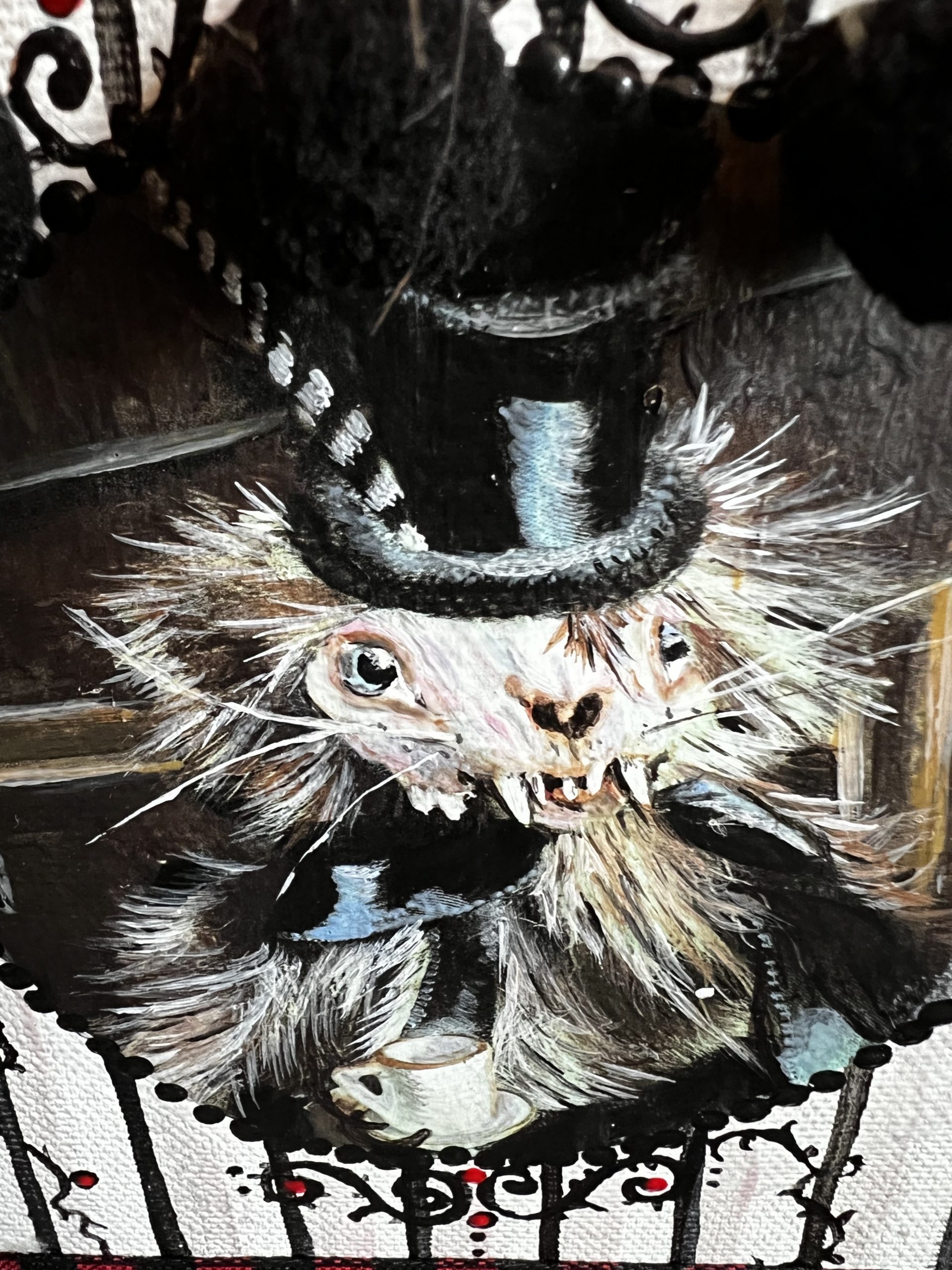 close-up hand painted furry weasel with a skull face wearing a top hat and black ribbon bow